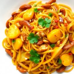 Spicy Asian Noodle Stir-Fry with Crispy Potato and Nut Topping